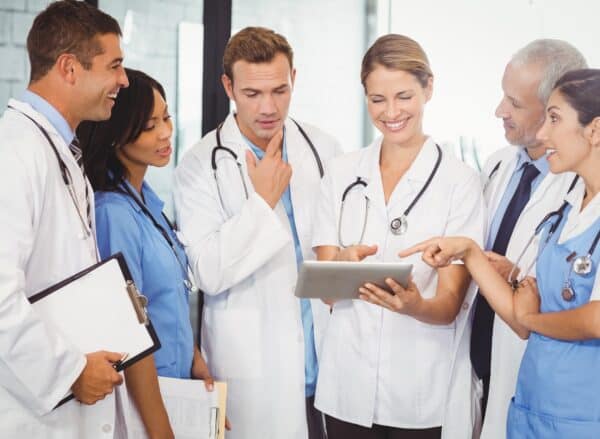 Medical team interacting and using digital tablet