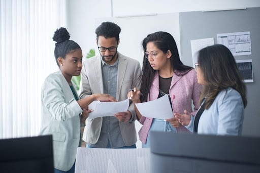 A group of medical professionals review a case file of a patient