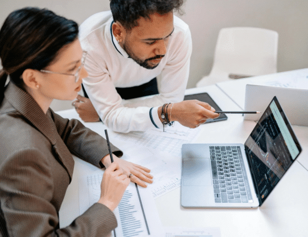 Two health professionals looking at predictive analytics on a screen