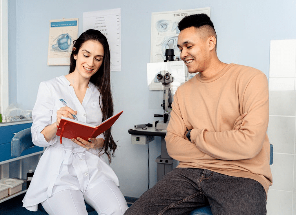 A doctor talking a patient through his medical results, both smiling