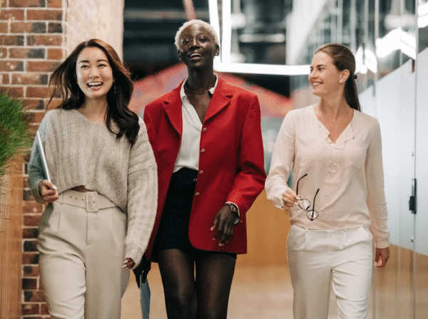 Women team members smiling and walking together