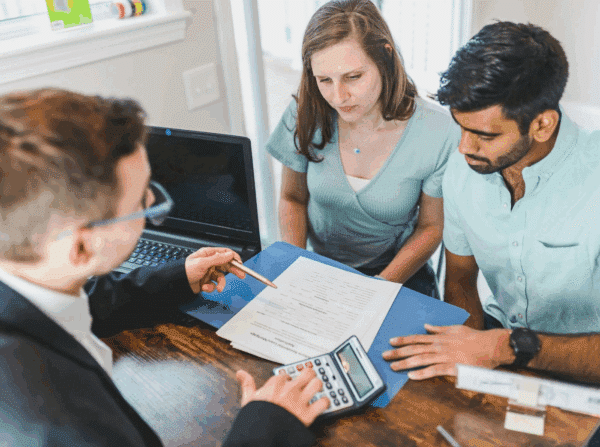 A couple talking about potential investments with an expert